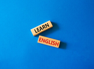 Learn English symbol. Wooden blocks with words Learn English. Beautiful blue background. Business and Learn English concept. Copy space.