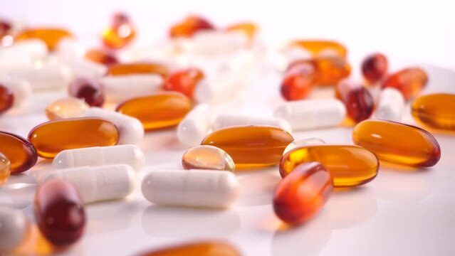 Various white, orange and transparent Capsules - Pills isolated on white Background