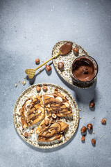 crepes with banana and chocolate. breakfast or dessert. vertical image. top view. place for text