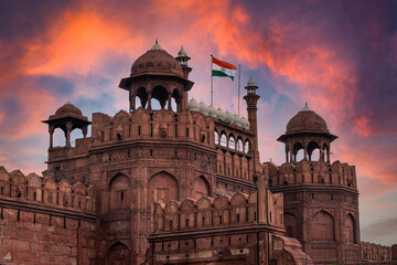 Red Fort or Lal Qila in Delhi with indian flag on foreground with moody sk.UNESCO World heritage site. Discover the India. Open world after covid-19