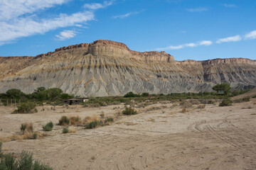 Abandoned barn at the foot of a large cliff in the Capitol Reef National Park, Utah