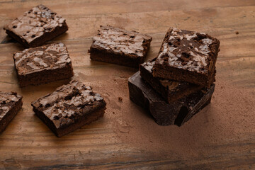 chocolate brownie, stacked on a wooden base