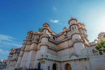 Romantic and luxury City Palace of Maharajah in Udaipur on Lake Pichola at sunset. Rajasthan, Discover the beauty of India. Open world after covid-19
