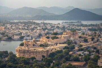 Romantic and luxury City Palace of Maharajah in Udaipur on Lake Pichola at sunset. Rajasthan, Discover the beauty of India. Open world after covid-19