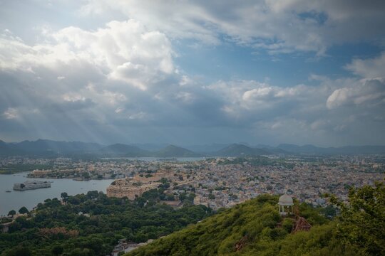 Aerial panoramic view of Udaipur, Lake palace, Lake Pichola at beautiful sunset and moody sky. Rajasthan, Discover the beauty of India. Open world after covid-19
