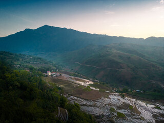 Fototapeta na wymiar The pouring water season makes the terraced fields of Y Ty commune, Lao Cai province, Vietnam appear with brown soil blending with the beautiful sky.