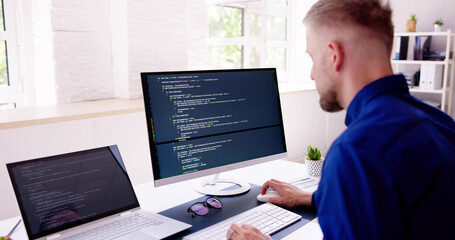 Fototapeta na wymiar Computer Programmer Writing Program Code On Computer