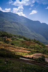 Obraz premium The pouring water season makes the terraced fields of Y Ty commune, Lao Cai province, Vietnam appear with brown soil blending with the beautiful sky.