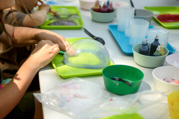 Making a slime for hands for a children's holiday. Chemical experiments.