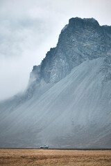 a passing car under a big mountain in Iceland