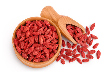 Dried goji berries in wooden bowl and scoop isolated on white background. Top view. Flat lay.