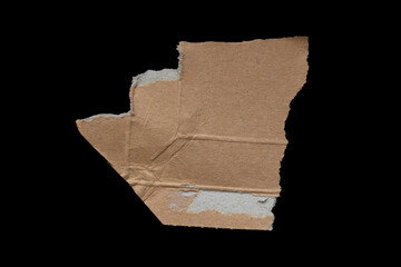 Ripped piece of cardboard on isolated black background