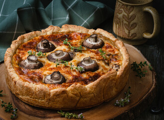 Fresh homemade quiche with mushrooms and thyme.