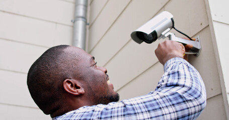 African American Handyman With CCTV Camera