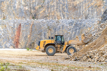 Excavator mines stone in quarry