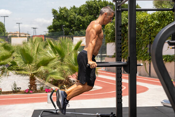 Mature man training fitness under the summer sun
