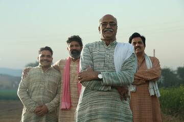 Happy rural Indian group of farmers dramatic silhouette shot standing aligned composition 