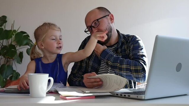 Dad tries to work at home, but his daughter distracts him.