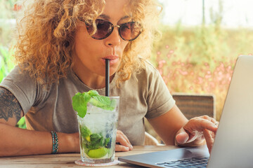 Summer and online job new modern business concept lifestyle with one woman drinking cocktail with...