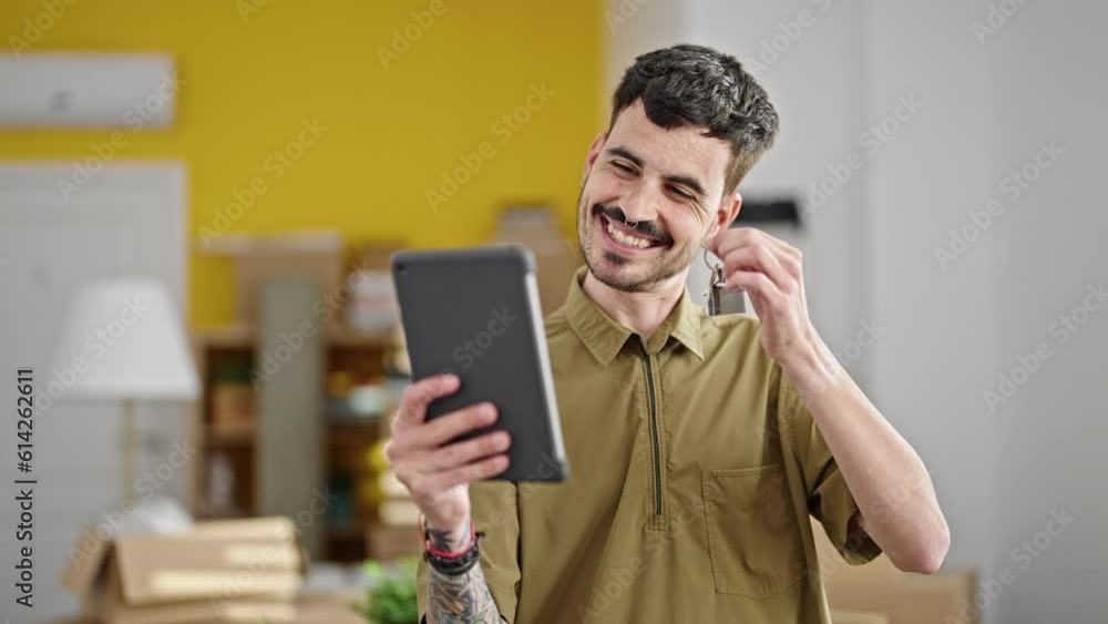 Sticker Young hispanic man having video call holding key at new home