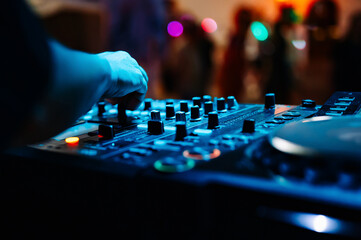 DJ Hands creating and regulating music on dj console mixer in concert