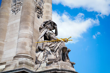 statue in a column with a gold sword