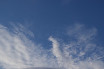 Peaceful blue sky with light clouds