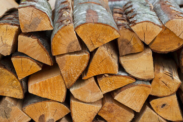 stack of aspen firewood as a textured wooden background 