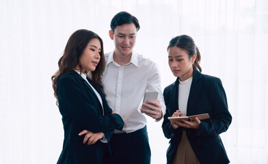 Mentor, manager advice younger colleagues in workplace. Businesspeople discussing or planning...
