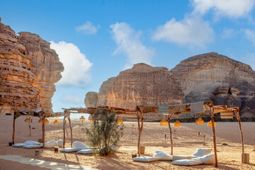Outdoor lounge in front of elephant rock erosion monolith standing in the desert, Al Ula, Saudi Arabia