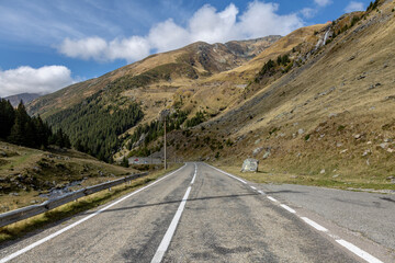 A mountain road leads towards the horizon with road marking. Transfagarash - the most beautiful and dangerous road in Europe