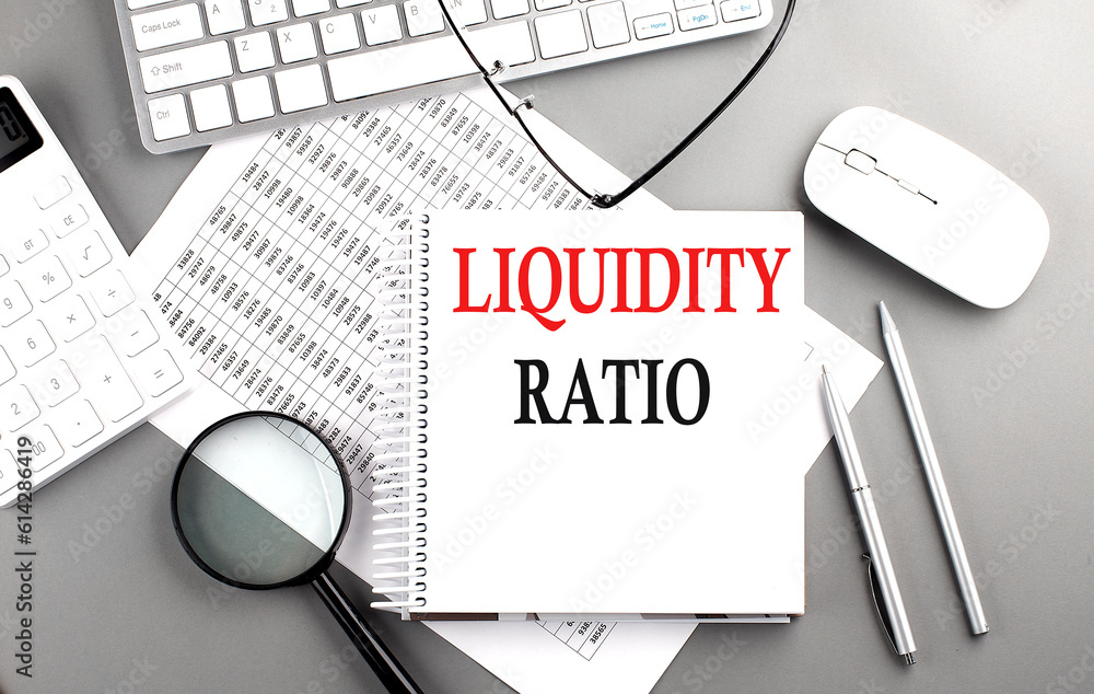 Poster LIQUIDITY RATIO text on notepad on chart with keyboard and calculator on grey background