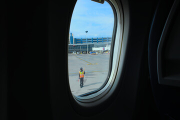 Fototapeta na wymiar View from airplane window. Oval portal to the outside world.