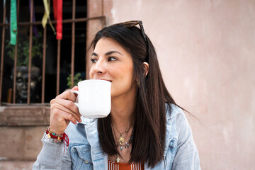 young adult woman enjoys her coffee while traveling. lifestyle and travel concept