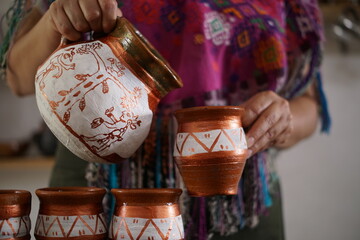 Guatemalan mayan woman preparing hot chocolate or coffee