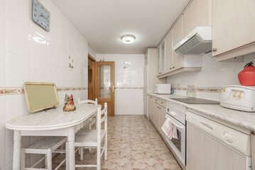 large kitchen furnished with antique decoration, white wooden folding dining table