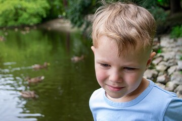 Small boy playing on a pond
