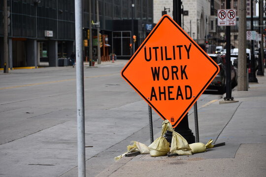 Utility Work Ahead Orange Construction Street Sign In Urban City