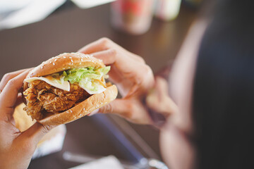 hand holding a hamburger