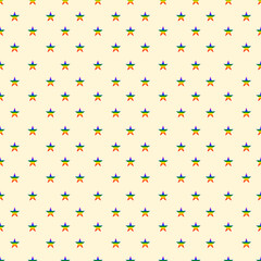 Seamless pattern of rainbow stars on light yelow background
