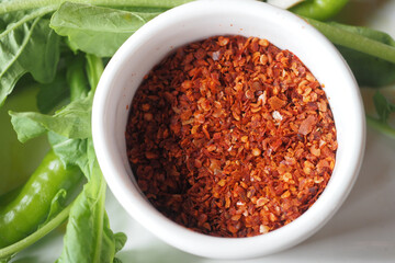 top view of chili flakes in a bowl on table 