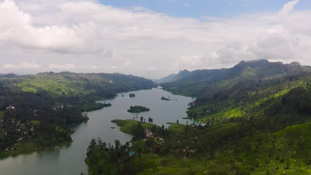 A lake among the hills with tea plantations in the mountains. Maskeliya, Castlereigh, Sri Lanka.