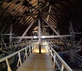 Wooden trusses supporting the roof of an old Gothic church, showcasing medieval engineering, craftsmanship, and the architectural ingenuity of historical Europe.