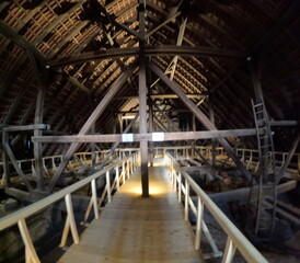 Wooden trusses supporting the roof of an old Gothic church, showcasing medieval engineering, craftsmanship, and the architectural ingenuity of historical Europe.