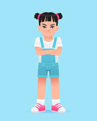 A disgruntled little girl stands with her arms crossed. A beautiful cute white baby in a blue summer jumpsuit.