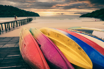 Beautiful sunset over bridge with colored canoe in tropical sea at Koh Kood Island, Trad, Thailand.