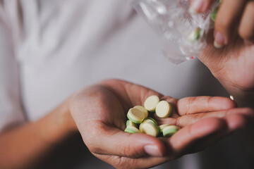 Female Hand Holding Colorful Pills
