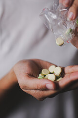 Female Hand Holding Colorful Pills