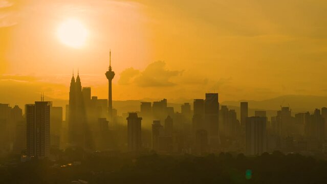 Cityscape Time lapse : Aerial Kuala Lumpur city view during morning overlooking the city skyline with beautiful burning skies in Malaysia.