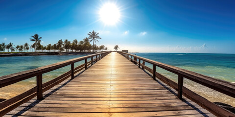 Fototapeta na wymiar Nature panoramic landscape: Amazing Panorama sandy tropical beach with silhouette coconut palm tree in crystal clear sea and scenery wooden bridge out of the horizon